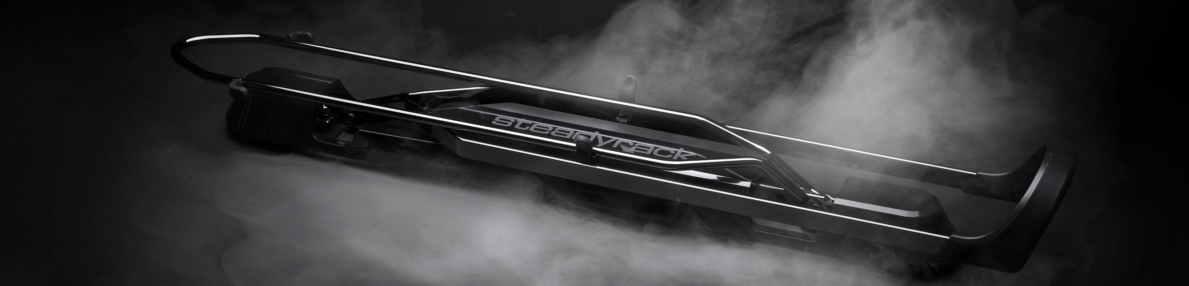 A bike rack on a black background surrounded in smoke. 